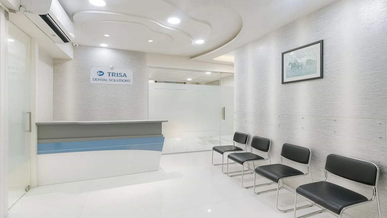 Reception desk with the Trisa Dental Solutions sign